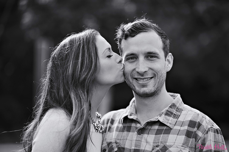 girl kissing her fiancee in Seattle, WA