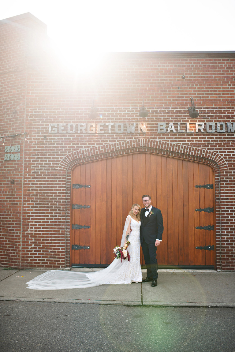 Bride & Groom in front of their wedding venue - the Georgetown Ballroom