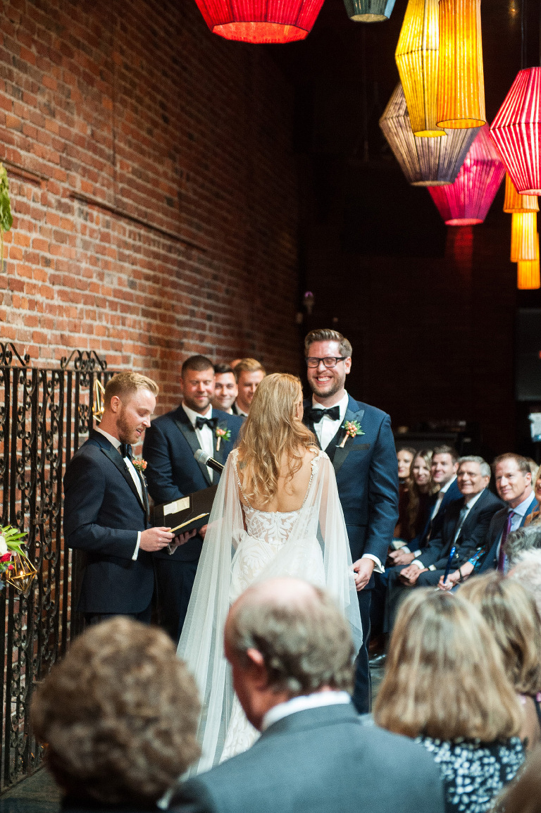 The groom cannot stop smiling at his bride during the ceremony